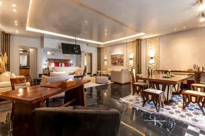 a large living room with tables and chairs at Palais Mirage d'Atlas, Hôtel & Spa in Marrakech