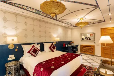 a hotel room with a bed and a desk at La Maison Arabe Hotel, Spa & Cooking Workshops in Marrakech