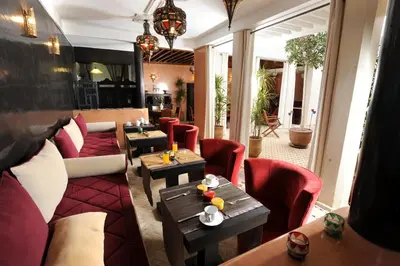 a restaurant with couches and tables in a room at Riad Belle Epoque in Marrakech