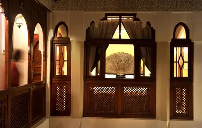 a room with three windows with curtains on it at Riad Belle Epoque in Marrakech