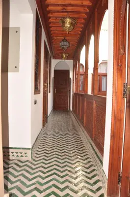 a hallway of an old building with a wooden ceiling at Riad Belle Epoque in Marrakech