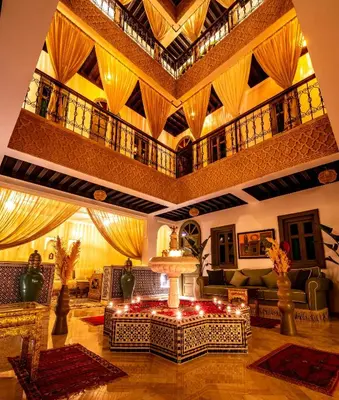a living room with a table in the middle of a room at Riad Hamdane Rooftop & SPA in Marrakech