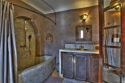 a bathroom with a tub and a sink at Riad Shemsi in Marrakech