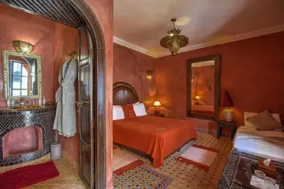 a bedroom with a bed and a mirror at Riad Shemsi in Marrakech