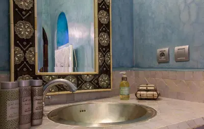 a sink in a bathroom with a mirror at Riad Shemsi in Marrakech