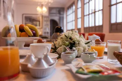 a table with breakfast foods and drinks on it at Riad Shemsi in Marrakech