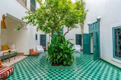 a room with a green and white checkered floor and a tree at Hotel & Spa Dar Sara in Marrakech