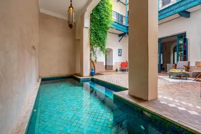 a swimming pool in a house with a tile floor at Hotel & Spa Dar Sara in Marrakech