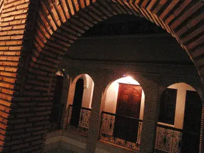a building with an archway with a door on a balcony at Riad Assia in Marrakech