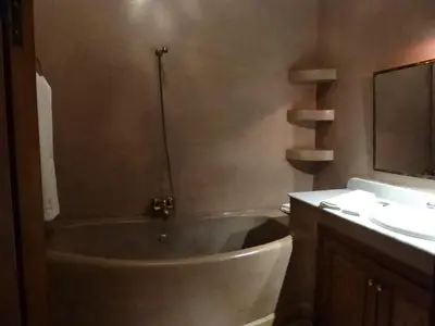 a bathroom with a bath tub and a sink at Riad L'Emir in Marrakech