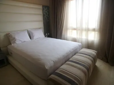 a bedroom with a white bed and a window at Jnane Gueliz in Marrakech