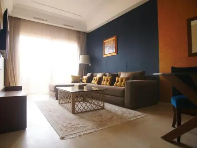 a living room with a couch and a table at Jnane Gueliz in Marrakech