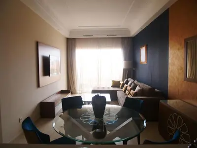 a living room with a couch and a glass table at Jnane Gueliz in Marrakech