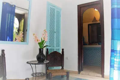 a room with a vase on a table and a mirror at Dar Soukaina in Marrakech