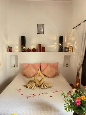a bedroom with a bed with flowers on it at Dar Soukaina in Marrakech