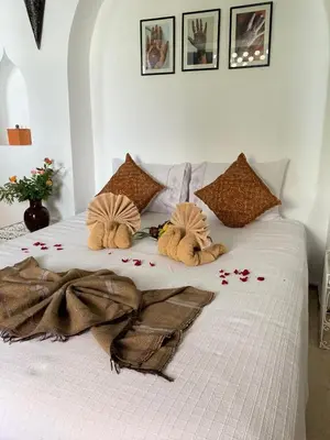 a white bed with flowers on top of it at Dar Soukaina in Marrakech