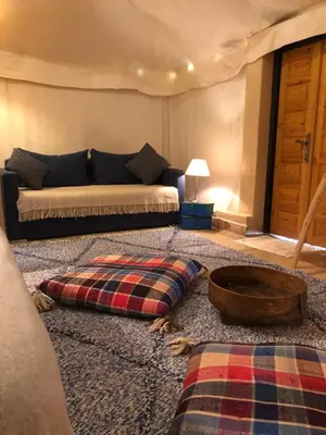 a living room with a couch and a bowl on the floor at Manzil La Tortue in Douar Caïd Layadi