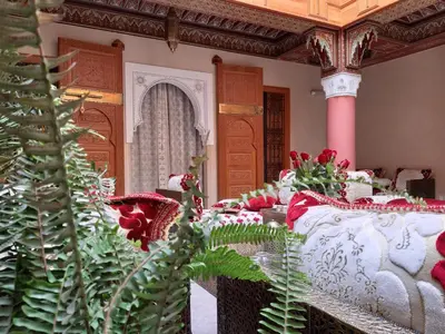 a room with a bed with red and white at Riad Miral in Marrakech