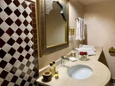 a bathroom with a sink and a mirror at Riad Miral in Marrakech