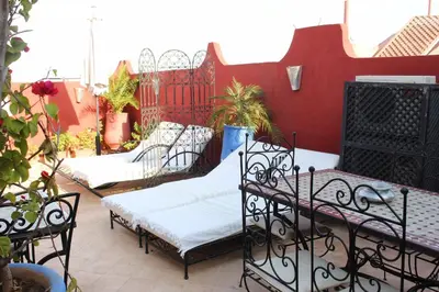 a group of beds sitting on a patio at Riad Mboja Chez Ali Baba in Marrakech