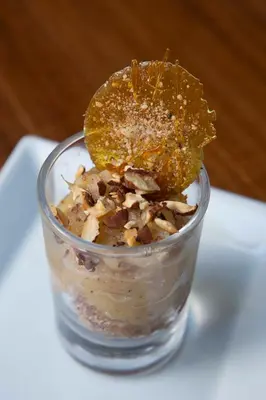 a dessert in a glass container on a white plate at Riad Dar Alfarah in Marrakech