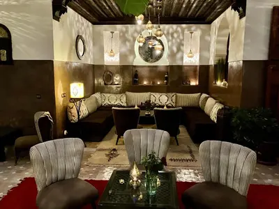 a living room with a couch and a table and chairs at Riad Aya in Marrakech