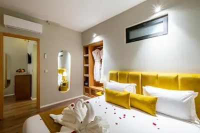 a bedroom with a large white bed with yellow pillows at Riad Mabrouk in Marrakech