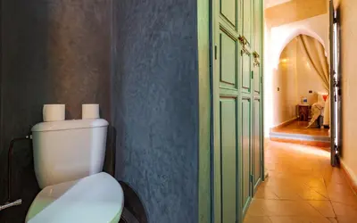 a bathroom with a white toilet in a hallway at Dar Picolina in Marrakech