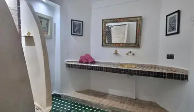 a bathroom with a sink and a mirror at Riad El Sagaya in Marrakech