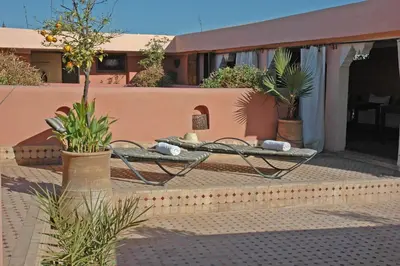 two chairs and a table on a patio at Riad El Sagaya in Marrakech