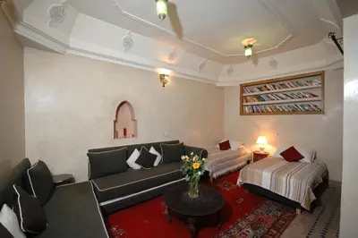 a living room with a couch and a bed at Riad El Sagaya in Marrakech