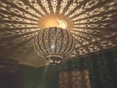 a chandelier hanging from a ceiling in a room at Dar Taliwint in Marrakech