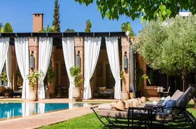 a backyard with a pool and a pavilion at Riad Jawad & Spa in Marrakech