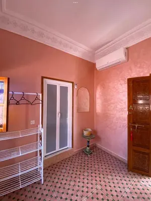 a room with a crib and a window at Dar Dikrayat in Marrakech