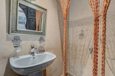 a bathroom with a sink and a shower at Riad Marwa Marrakech in Marrakech