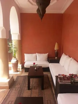 a living room with two beds and a table at Riad AZZA in Marrakech