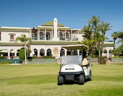 a golf cart parked in front of a building at Pickalbatros Hôtel Du Golf - Adults Friendly 16 Years Plus- All-Inclusive in Marrakech