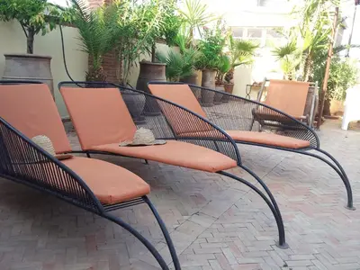 a group of chairs sitting on a patio at Riad Malika in Marrakech