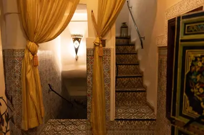 a hallway with curtains and a stairway with a stairwayngth at Abelia Riad - 2025 Guest Choice Award in Marrakech