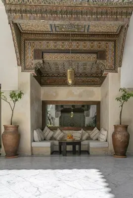 a living room with a couch and a fireplace at Riad Safar in Marrakech