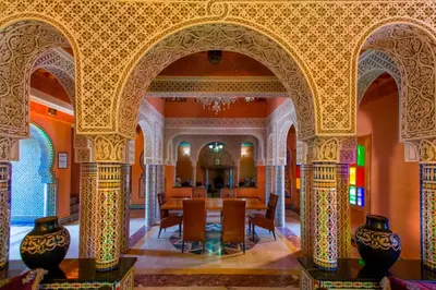a room with a table and chairs in a building at Villa Zahra Palmeraie in Marrakech