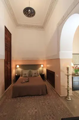a bedroom with a large bed in a room at La Villa Nomade in Marrakech