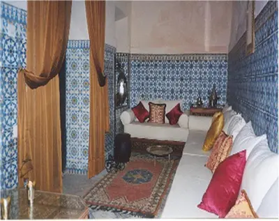 a living room with a couch in a room with blue at Riad El Filali in Marrakech