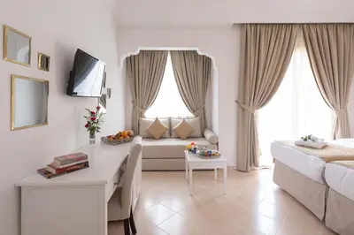 a living room with a couch and a table at Marrakech Ryads Parc All inclusive in Marrakech