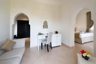 a living room with a couch and a table and a bed at Marrakech Ryads Parc All inclusive in Marrakech