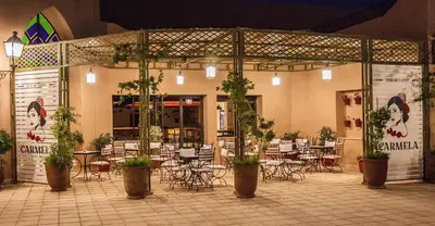 a restaurant with tables and chairs and potted plants at Marrakech Ryads Parc All inclusive in Marrakech