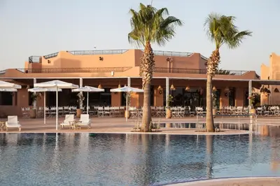 a resort with a swimming pool and palm trees at Marrakech Ryads Parc All inclusive in Marrakech