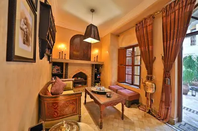 a living room with a couch and a table at Riad Zayane in Marrakech