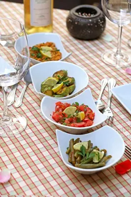 a table with three plates of food on it at Riad Zayane in Marrakech