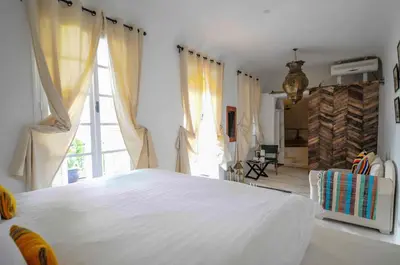 a white bedroom with a large bed and a window at Riad Villa Almeria Hotel & Spa in Marrakech